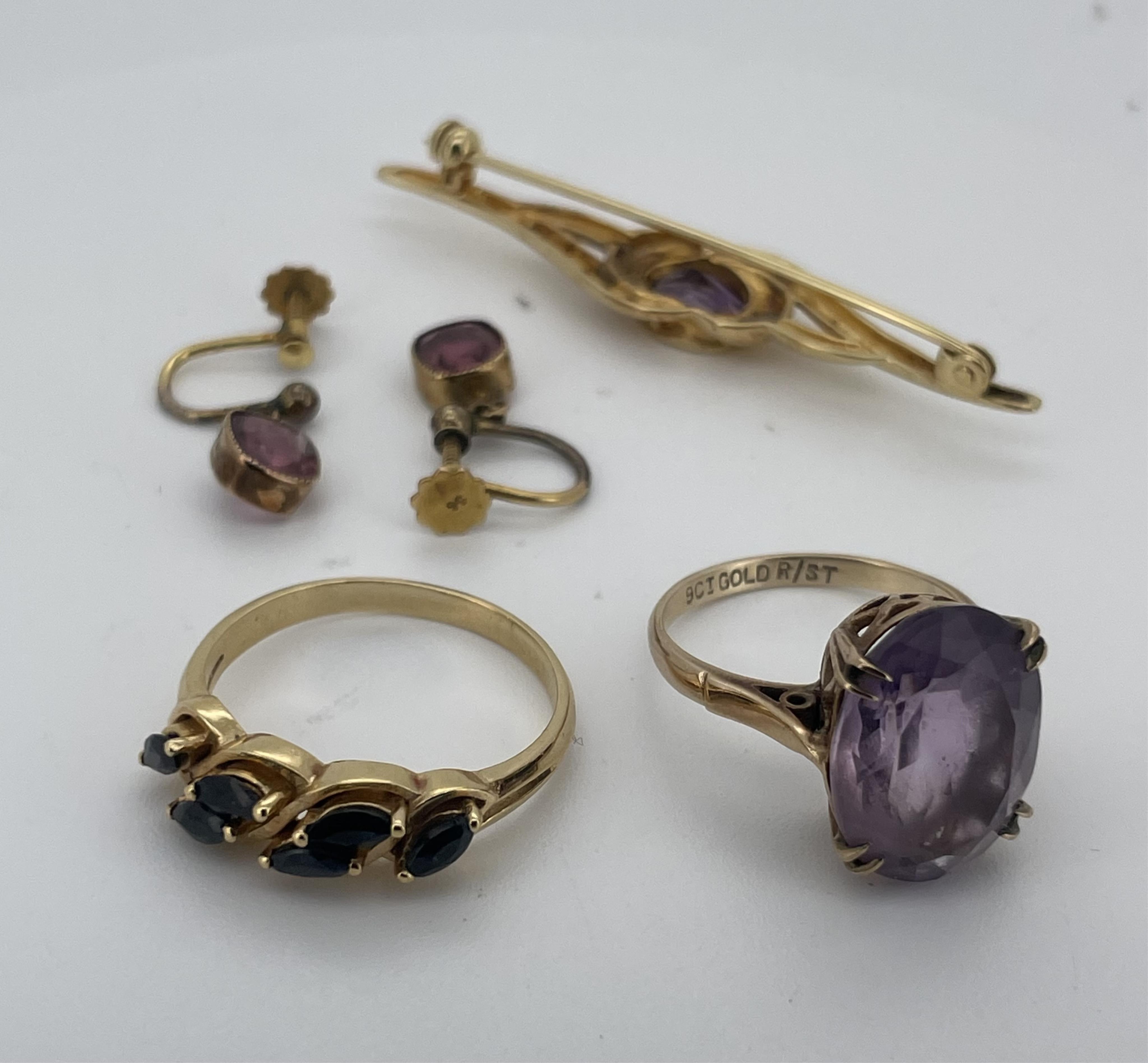 A collection of jewellery, comprising: an amethyst single stone ring, size N, stamped 9CT, gross weight approximately 4 grams; a pair of drop earrings suspending cushion-shaped pink tourmalines, in gold, screw fittings;